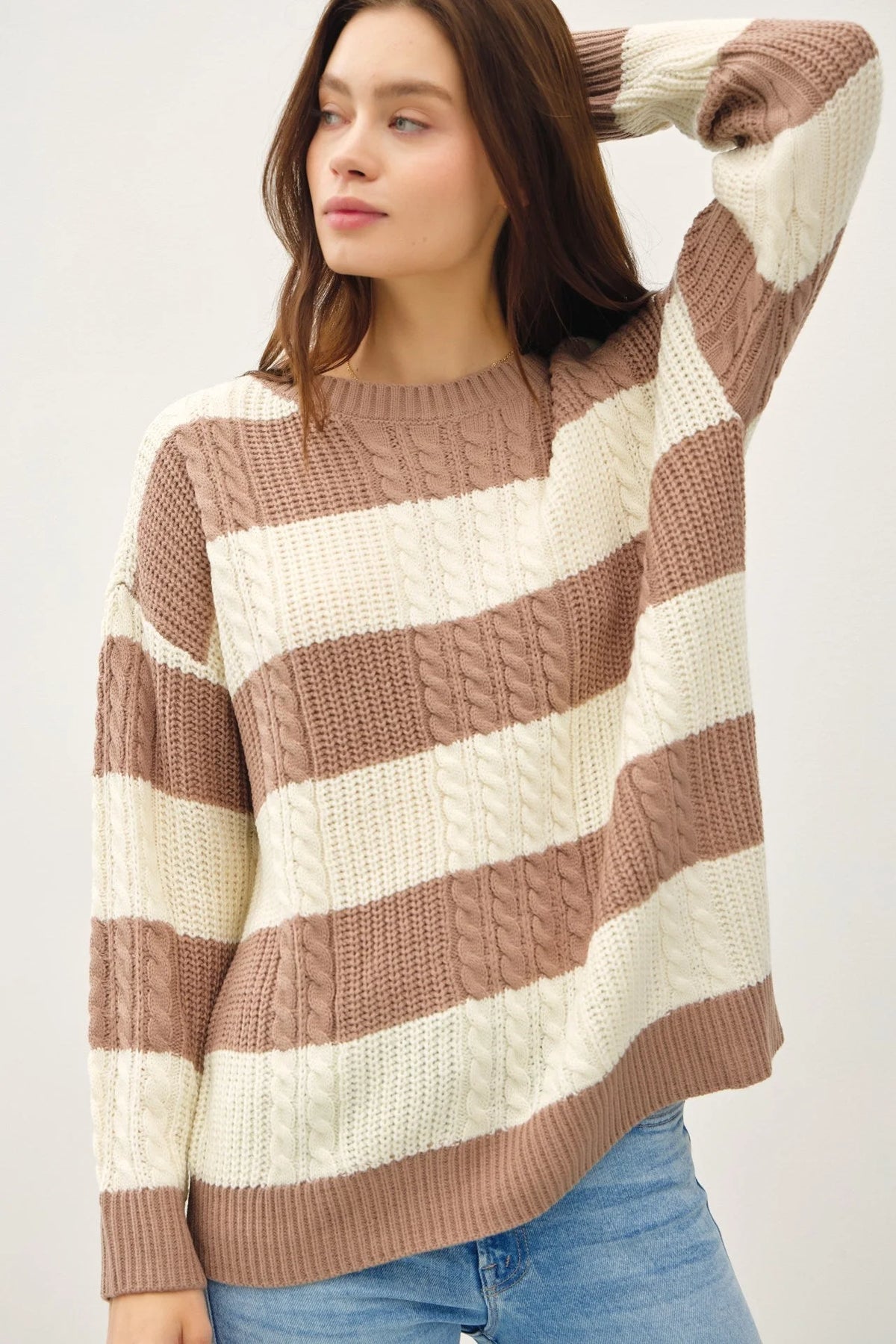 Striped cable knit crew neck sweater featuring wide beige and cream bands for a boho look