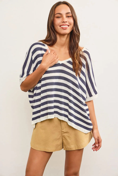 V-neck oversized stripe sweater top paired with tan shorts for casual style flexibility