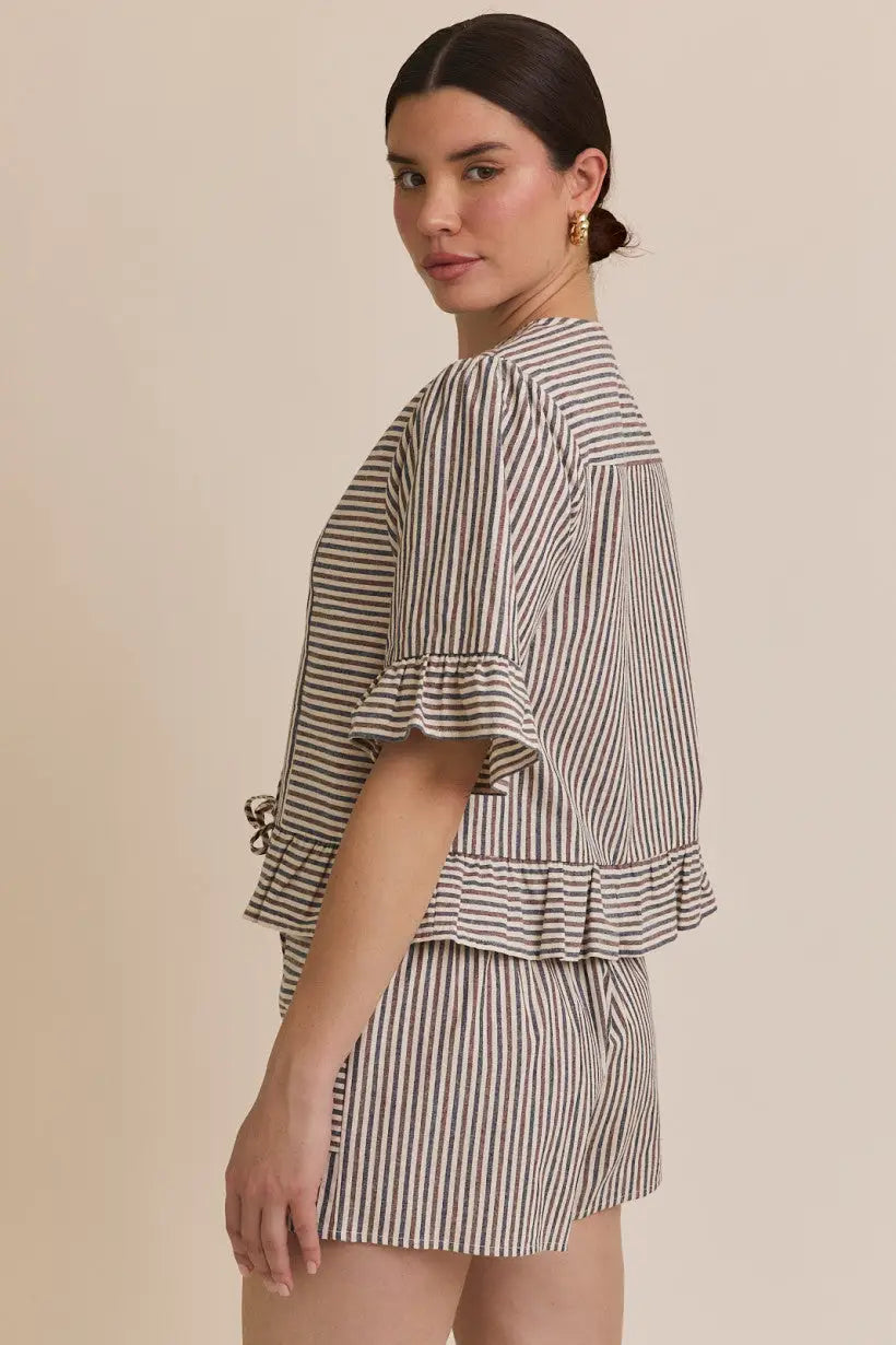 Striped pajama set featuring a front tie short sleeve blouse with ruffle hem stripe detail