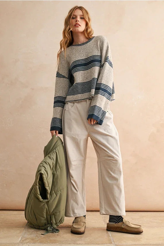 Striped navy and white sweater paired with corduroy barrel pants for a stylish look