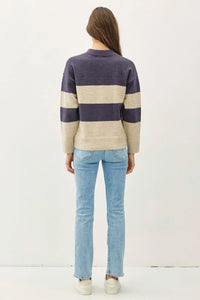 Striped pullover oversized sweater in navy and cream over light blue jeans