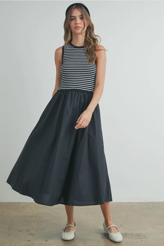 Striped sleeveless maxi dress with black skirt and white shoes