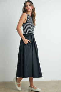 Striped sleeveless maxi dress with black skirt and white shoes