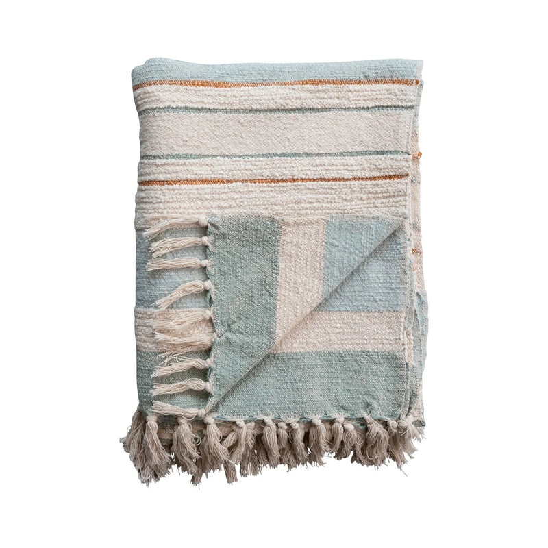 Woven cotton throw with stripes and fringe tassels in muted pastel colors