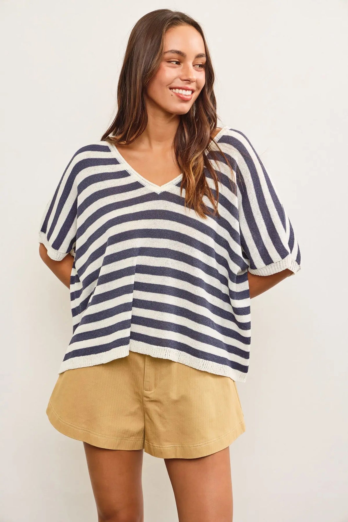 V-neck oversized stripe sweater top with khaki shorts for a stylish casual look