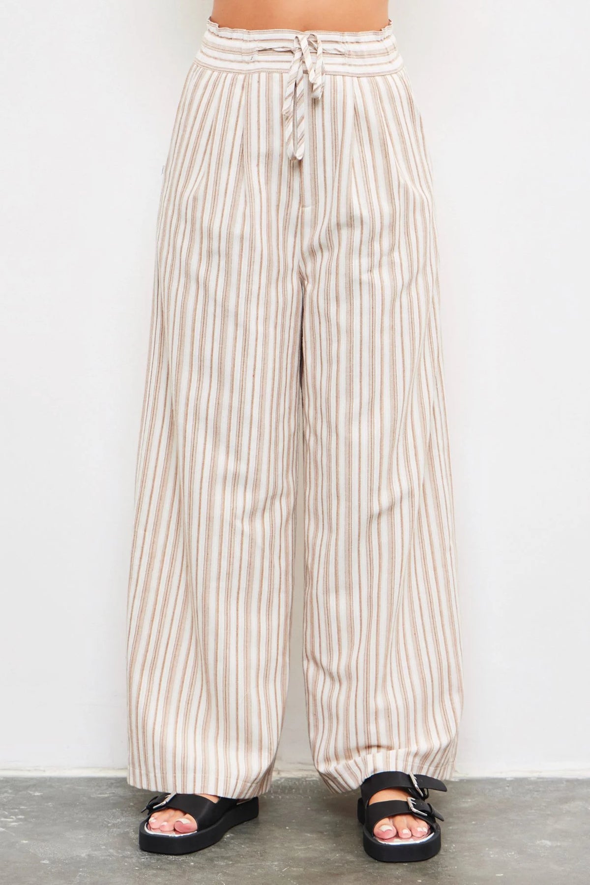 Striped wide-leg pants with a drawstring waist feature a tied waist band for style