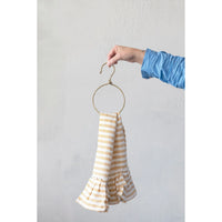 Striped yellow and white flowy dress with ruffled hem on a metal ring hanger