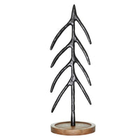 Stylized metal Christmas tree sculpture with branching limbs on a wooden base