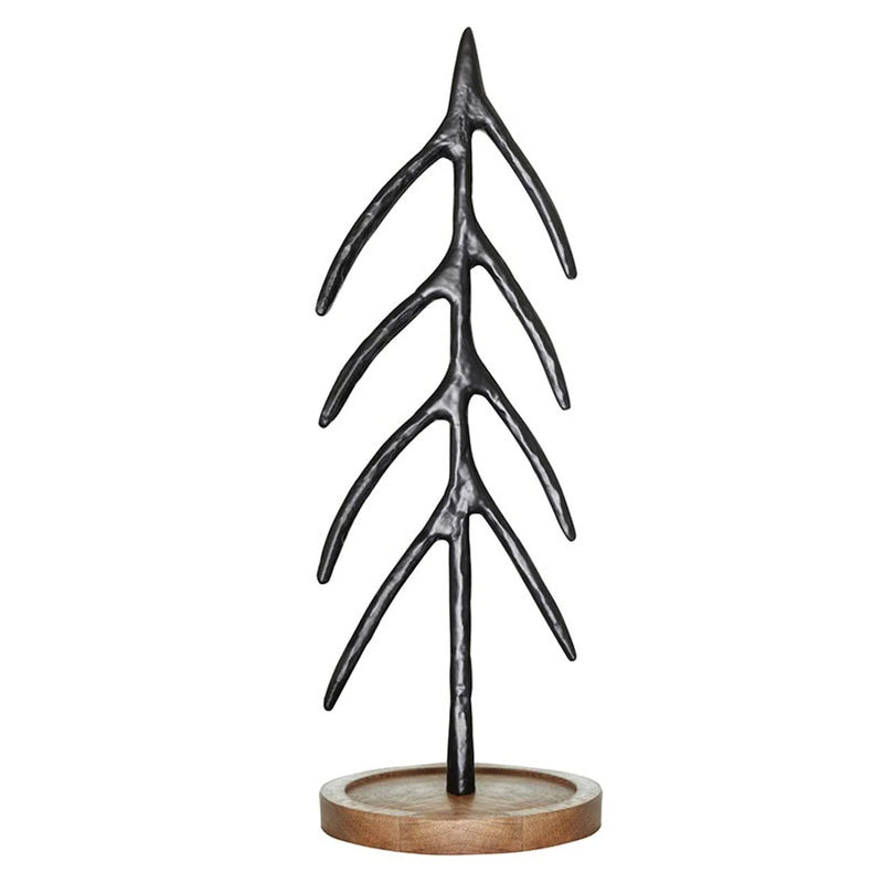 Stylized metal Christmas tree sculpture with branching limbs on a wooden base