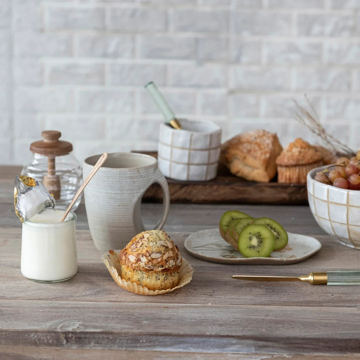 Table setting featuring a plate of food and milk beside a 14 oz Glass Honey Jar with Acacia Wood Lid