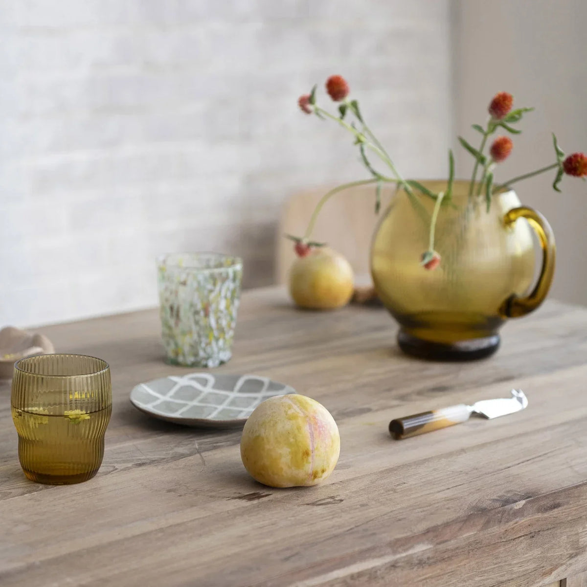 Table displaying 8 OZ Fluted Drinking Glass with a vase and two glasses