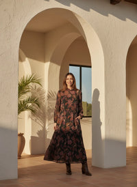 Tall woman wearing LOST + WANDER WHISPERS OF BOHEMIA MAXI DRESS with floral pattern and ankle boots