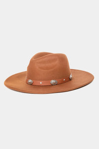 Tan felt cowboy hat featuring decorative silver conchos on the concho shell band