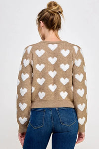 Tan raised heart pullover sweater paired with blue jeans for women’s boho chic clothing