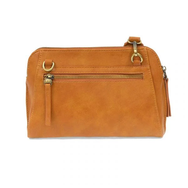 Tan vegan leather handbag with gold-toned hardware and zip closure, featuring woven wristlet strap