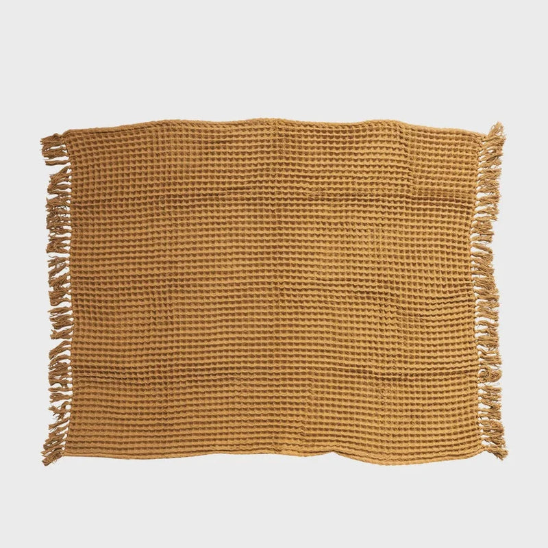 Tan woven placemat with fringed edges and textured waffle weave pattern for Waffle Weave Throw