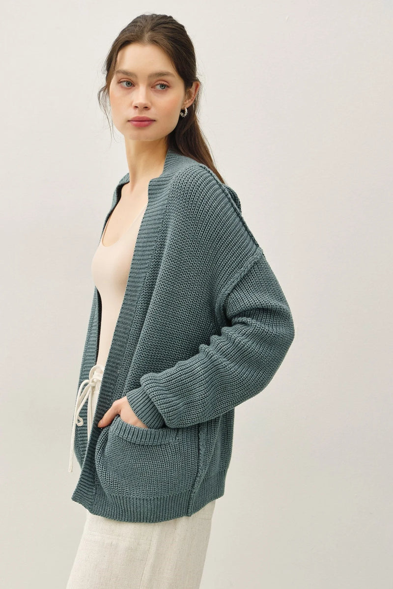 Teal chunky knit drop shoulder cardigan with textured knit, hood, and drawstring pockets