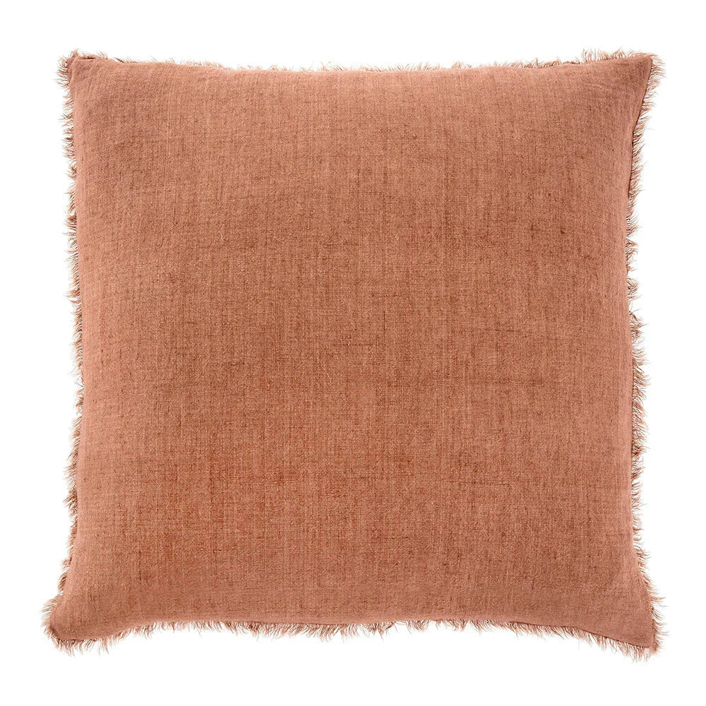 Terracotta square throw pillow with frayed edges perfect for a boho free spirit decor