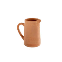 Unglazed terracotta pitcher with curved handle for boho decor style