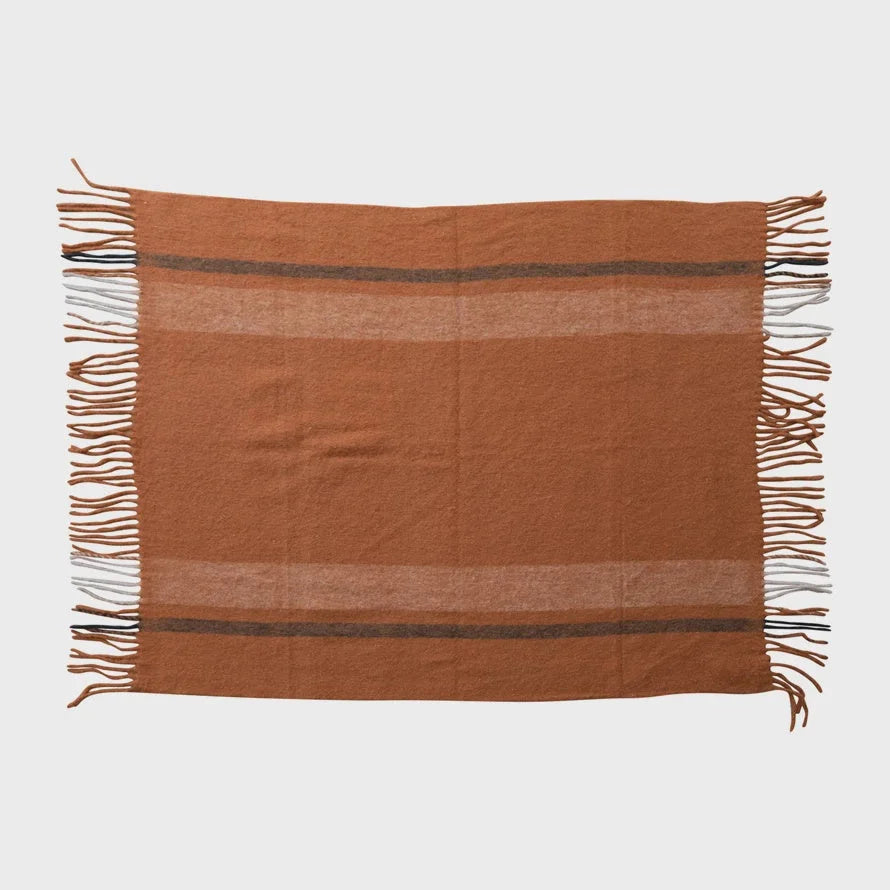 Terracotta woven wool throw with fringe and brown stripes, made from New Zealand wool