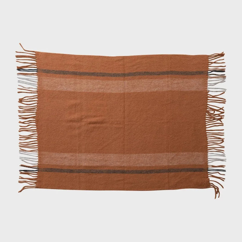 Terracotta woven wool throw with fringe and brown stripes, made from New Zealand wool