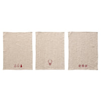 Three beige linen tea towels with cotton embroidered Christmas designs in natural and red