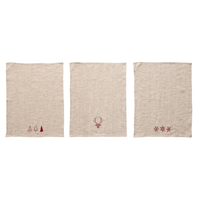 Three beige linen tea towels with cotton embroidered Christmas designs in natural and red