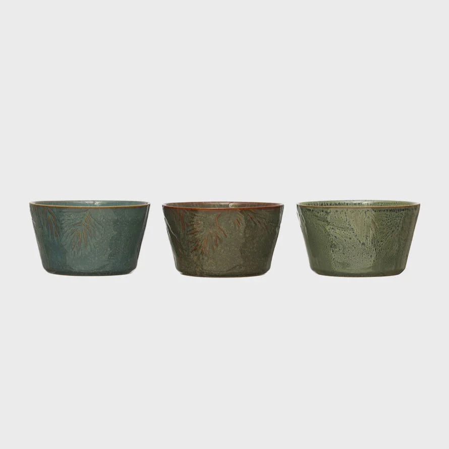 Three embossed stoneware bowls in earthy green and brown tones for elegant dining