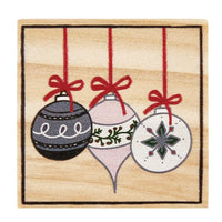 Three decorative Christmas ornaments on red ribbons, complementing Treasure Box Earrings design