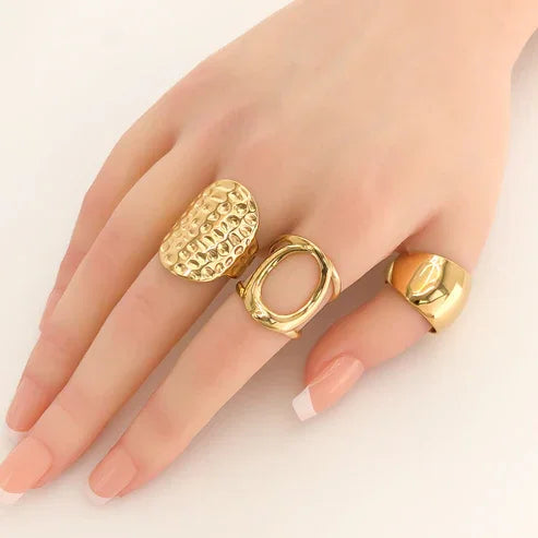 Water resistant gold adjustable oval rings on hand for elegant fashion accessory display