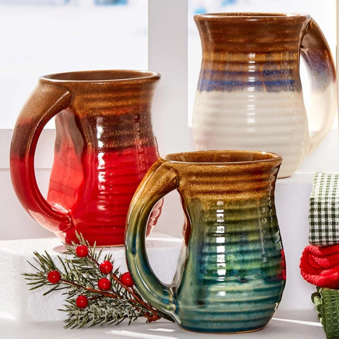 Three Blue Cozy Ceramic Mugs displayed elegantly on a window sill