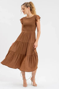 Smocked tiered midi dress featuring a tiered brown design and flutter sleeves