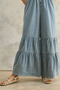 Tiered denim palazzo pants included in the TIERED BOTTOM DETAIL CHAMBRAY DENIM JUMPSUIT