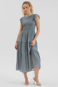 Dusty blue smocked tiered midi dress with flutter sleeves and gathered waist