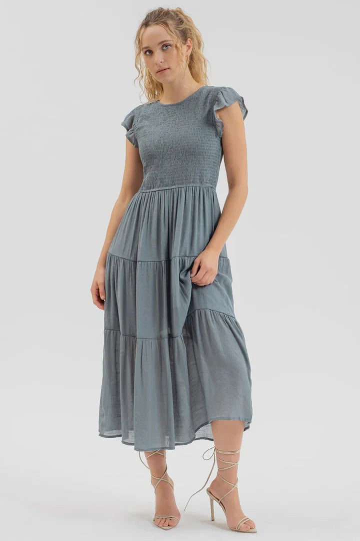 Dusty blue smocked tiered midi dress with flutter sleeves and gathered waist