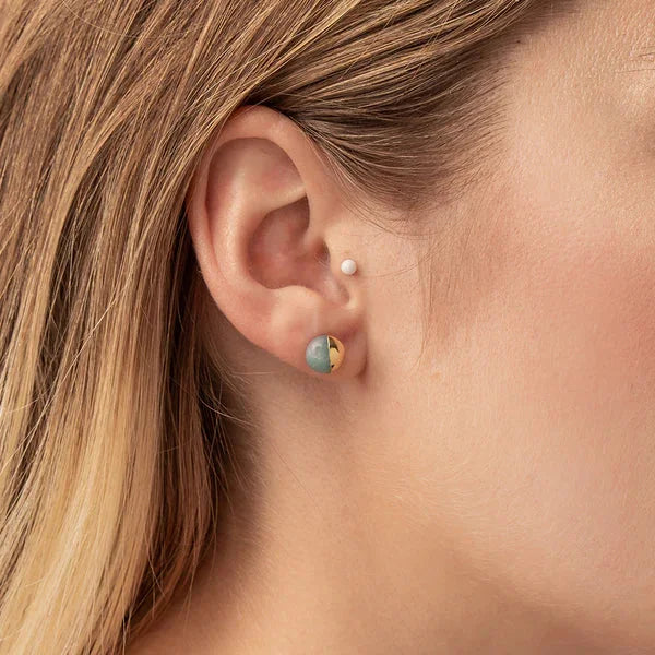 Turquoise and gold stone stud earring in a pierced earlobe for a boho look