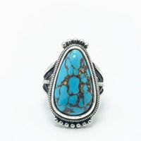 Chunky turquoise adjustable statement ring with silver band and intricate detailing