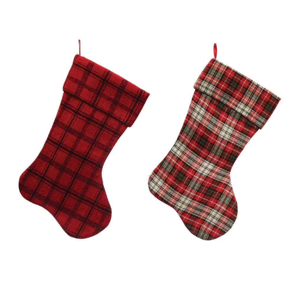 Two Christmas stockings with red plaid patterns displayed on a stocking holder