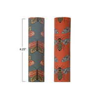 Two decorative cylindrical tubes in orange and gray with butterfly and bee patterns for safety matches