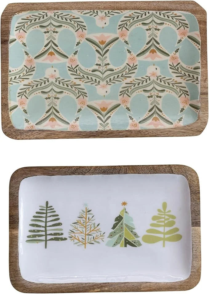 Two decorative serving trays with winter-themed tree and botanical patterns in elegant design