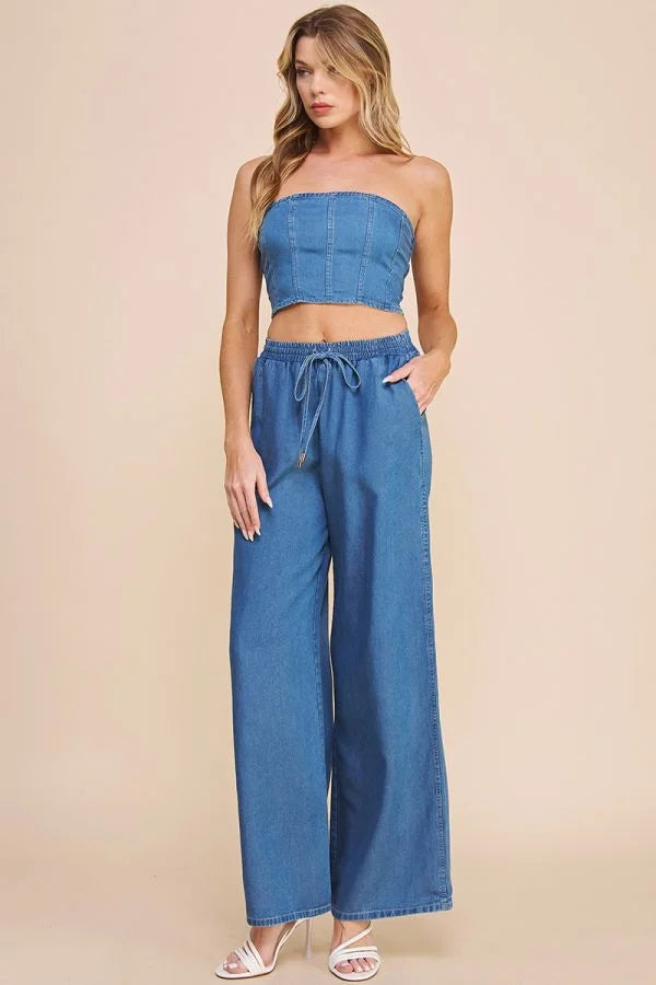 Two-piece outfit featuring washed chambray denim strapless crop top and wide-leg pants