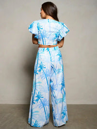 Two-piece tropical outfit featuring blue palm trees, perfect for women’s boho chic clothing