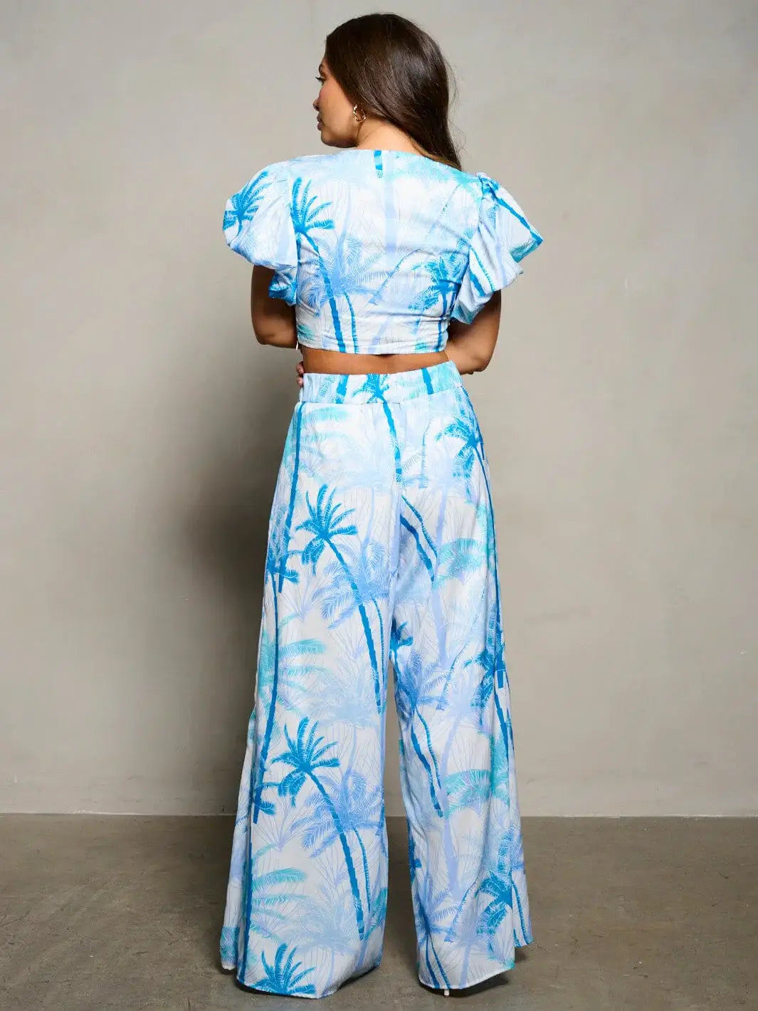 Two-piece tropical outfit with blue palm tree print, ideal for women’s boho chic clothing