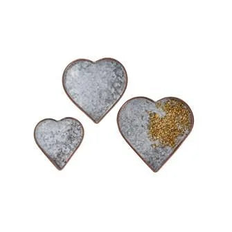 Two small copper heart plates adorned with gold glitters for decorative use