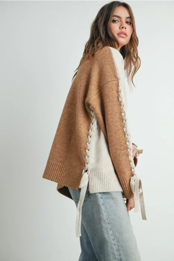 Two-tone crew neck long sleeve pullover sweater with lace-up sides and ribbon ties