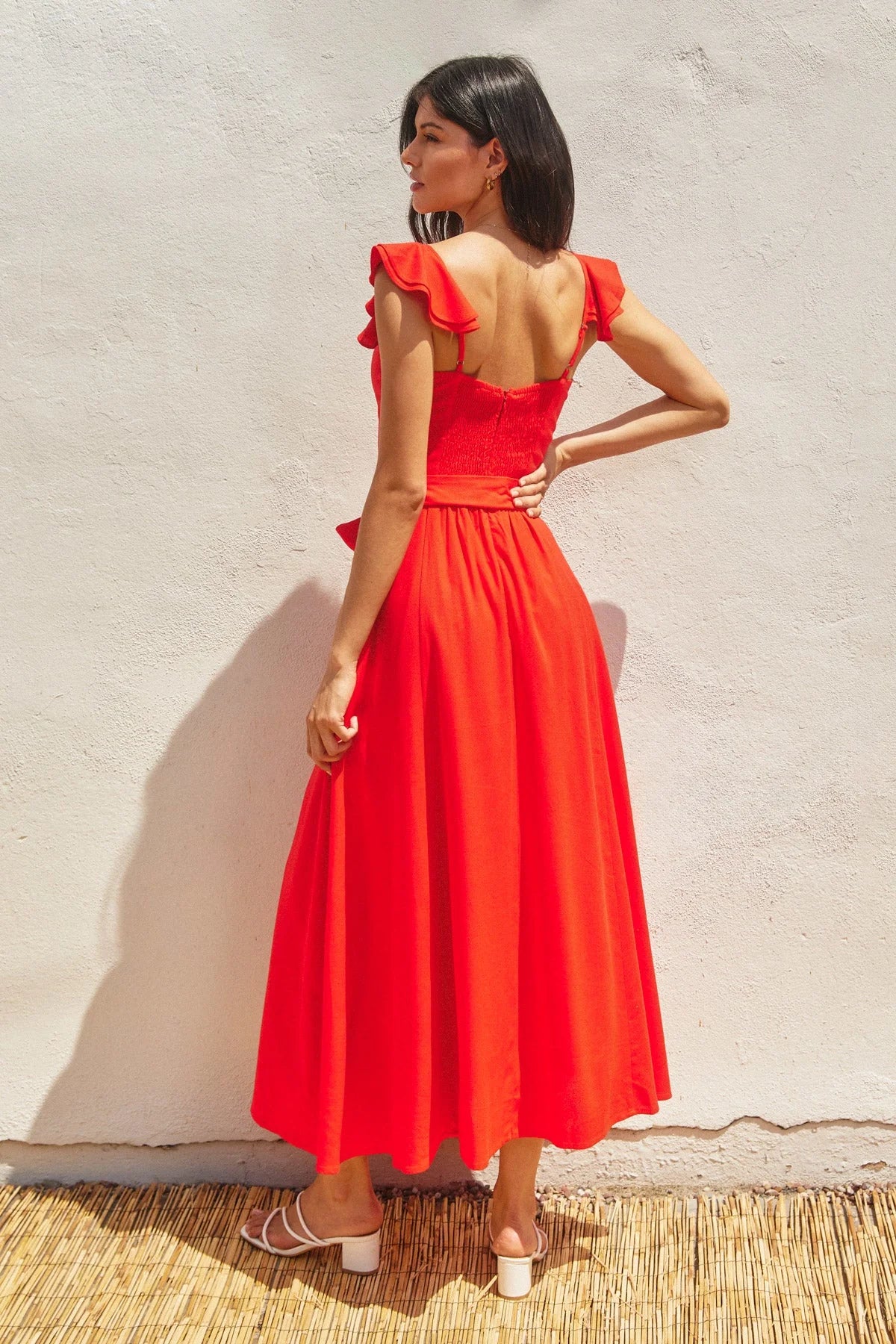 Vibrant red midi-length corset flutter dress with ruffled straps and tie waist