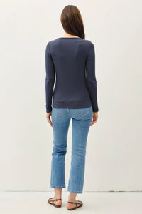 Back view of model in Basic Boat Neck Long Sleeve Knit Top with light blue jeans and sandals