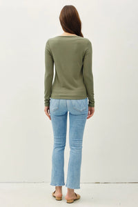 Back view of individual in a sage green BASIC BOAT NECK LONG SLEEVE KNIT TOP and jeans