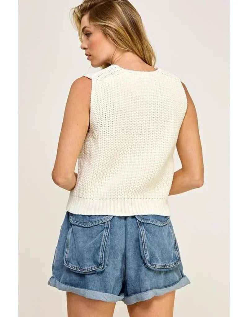 Back view of a casual sweater vest in cream paired with denim shorts for all seasons