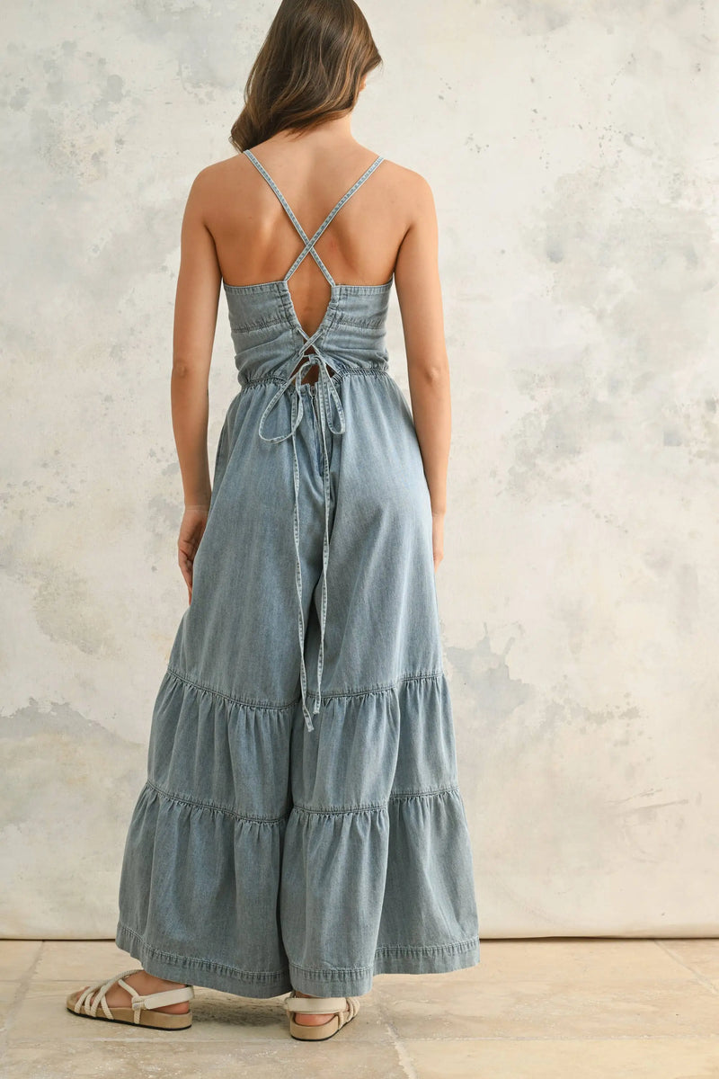 Back view of tiered chambray denim jumpsuit showcasing bottom detail and casual style